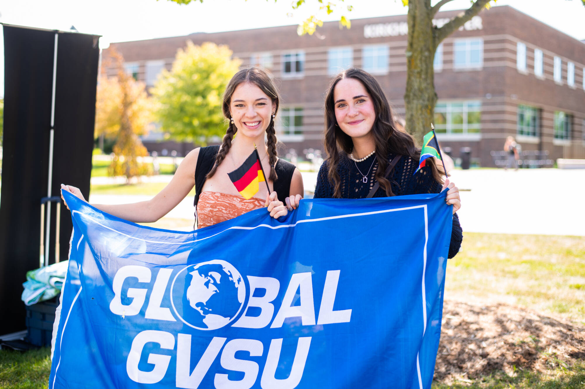 Staff and students, including first-year students Cora Adamczak, left, and Leah Yancy, joined the Global Laker Festival for lawn games, international music, snacks, and other activities in front of the carillon tower September 4. (Photo releases on f...